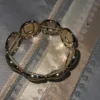 One bracelet with elastic put on goldish color not too bright gold